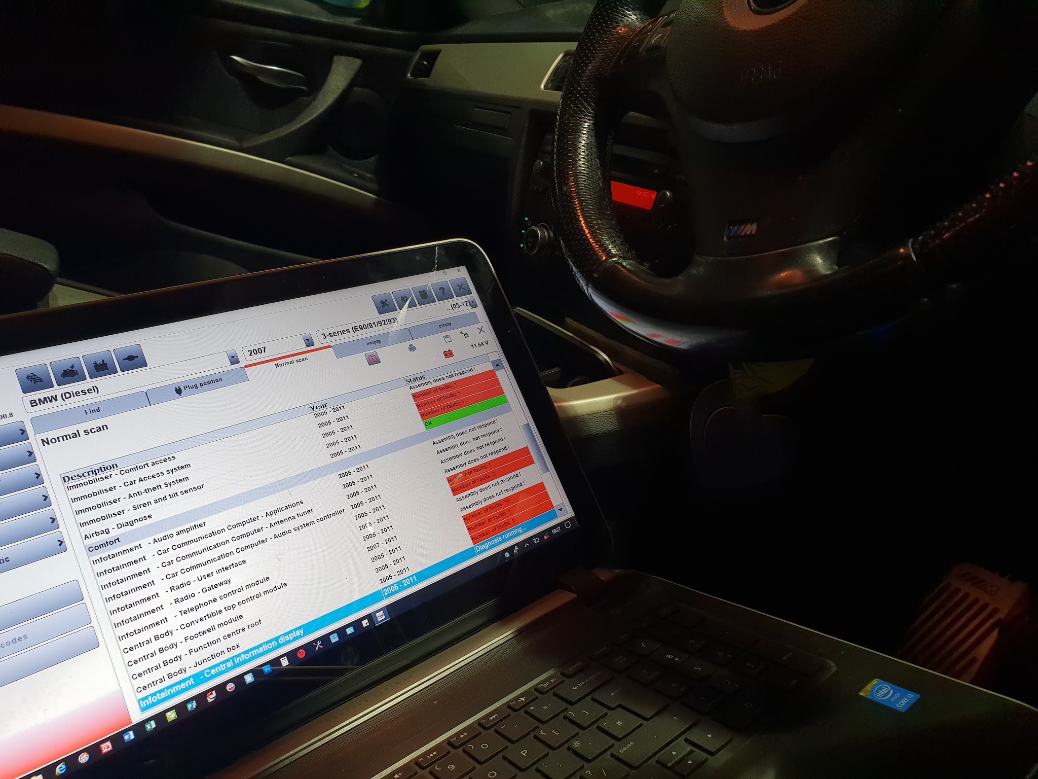 Diagnostic software on a laptop running a scan inside a customer's car