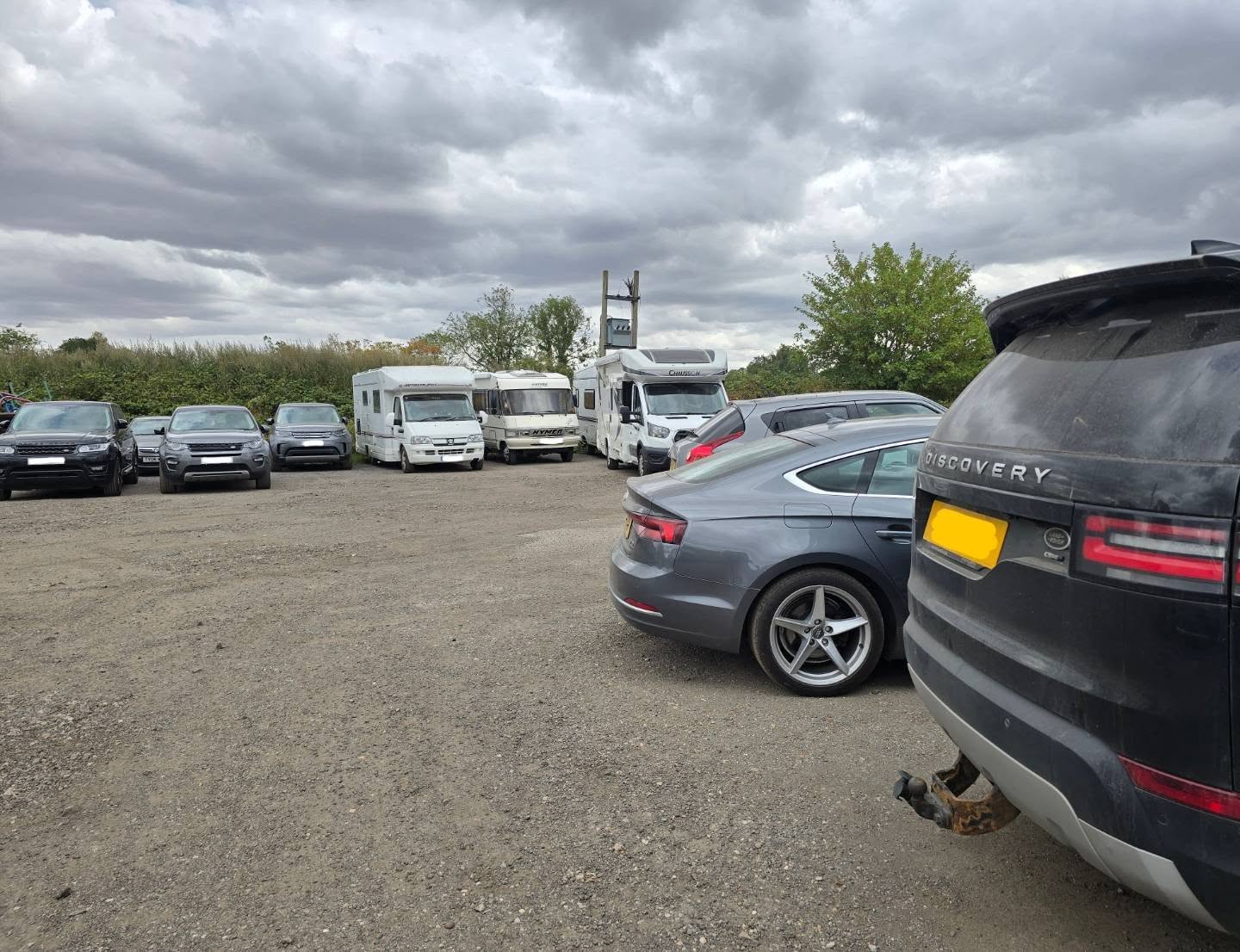Motorhomes, an Audi and a Land Rover Discovery waiting in the car park